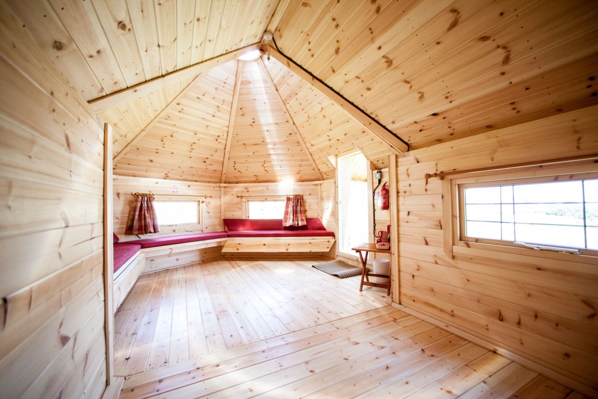 Ernest's Retreat - Camping Cabin interior, large seating area includes 2 fold out benches to sleep children